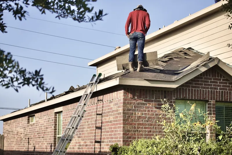 Professional roofer working on a residential roof in New Miami